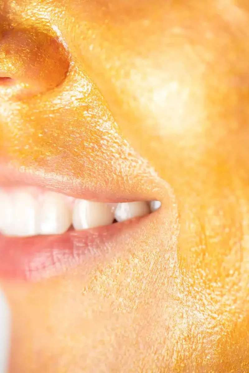 trendy-gold-face-mask-on-womans-face-MKPAURF